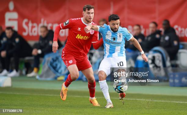 Albion Vrenezi of Muenchen and Oscar Schoenfelder of Regensburg fight for the ball during the 3. Liga match between TSV 1860 Muenchen and Jahn...