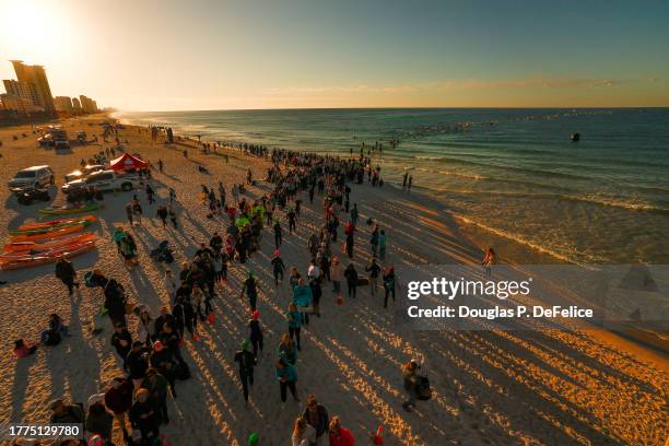 Athletes compete during the water segment of the Panama City Beach IRONMAN on November 4, 2023 in Panama City, Florida.