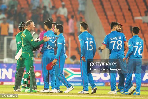 Andile Phehlukwayo and Rassie van der Dussen of South Africa celebrate their team's win over Afghanistan during the ICC Men's Cricket World Cup 2023...