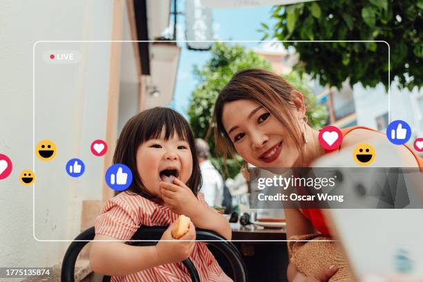 asian mother and her toddler daughter taking selfie with smartphone and share on social media - food and drink icon stock pictures, royalty-free photos & images