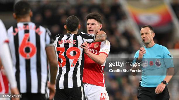 Newcastle player Bruno Guimaraes clashes with Arsenal player Declan Rice during the Premier League match between Newcastle United and Arsenal FC at...