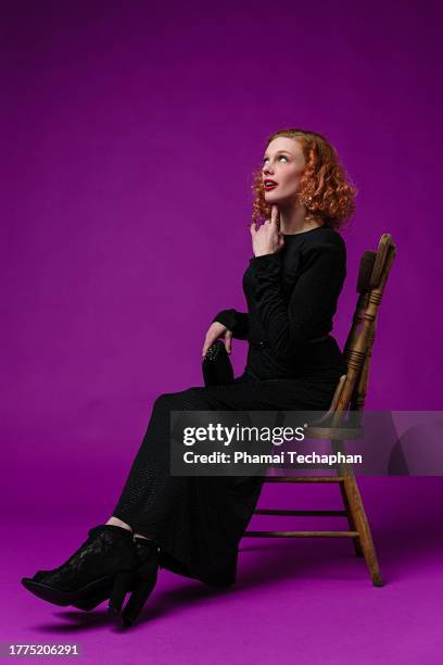 elegant woman wearing black dress - form fitted dress stock pictures, royalty-free photos & images