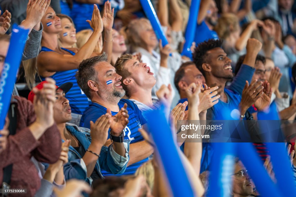 Spectators cheering in stadiumSpectators cheering in stadium