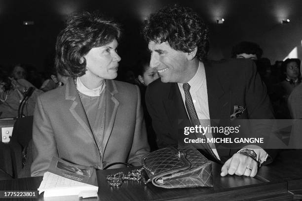French First Lady Danielle Mitterrand chats with former Minister of Culture Jack Lang on March 21, 1986 in Paris during the international symposium...