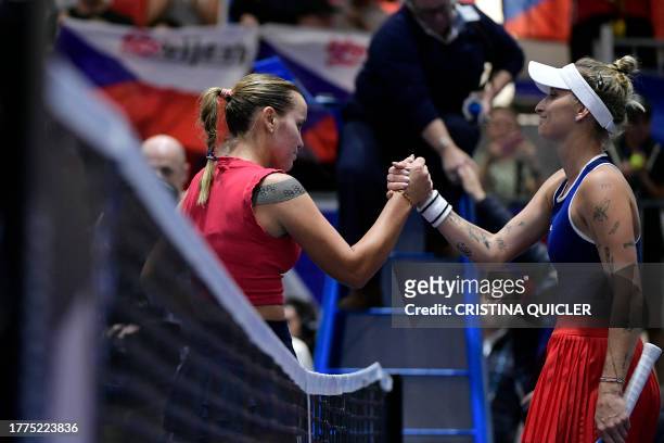 Czech Republic's Marketa Vondrousova shakes hands with US Sofia Kenin after winning the group stage group A singles tennis match between Czech...