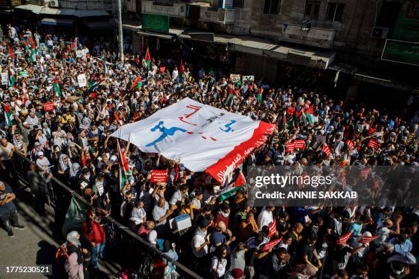 Jordan, Amman. Hundreds of demonstrators carry banners, placards and flags during a solidarity protest in support of Palestinians in Gaza, in...