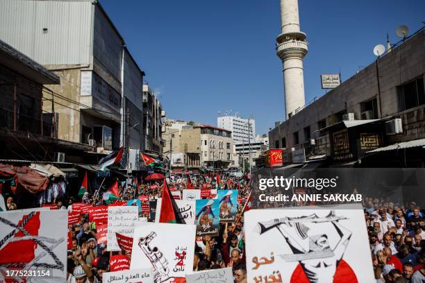 Jordan, Amman. Hundreds of demonstrators carry placards and flags during a solidarity protest in support of Palestinians in Gaza, in downtown Amman,...