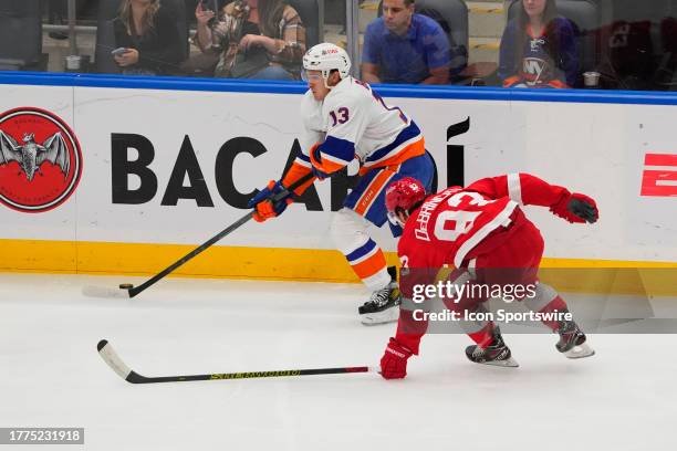 New York Islanders Center Mathew Barzal skates with the puck against Detroit Red Wings Right Wing Alex DeBrincat during the first period of the...