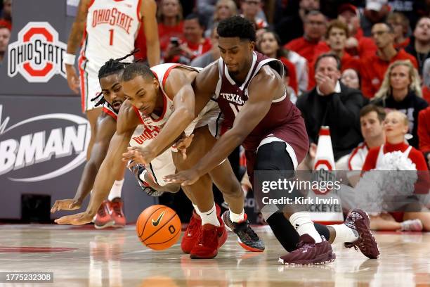 Henry Coleman III of the Texas A&M Aggies and Zed Key of the Ohio State Buckeyes dive after a loose ball during the first half of the game at Value...