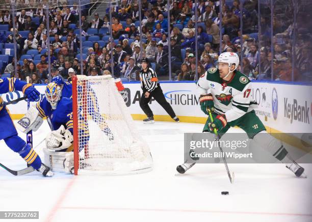 Marcus Foligno of the Minnesota Wild looks to pass from behind the net guarded by Devon Levi of the Buffalo Sabres during an NHL game on November 10,...