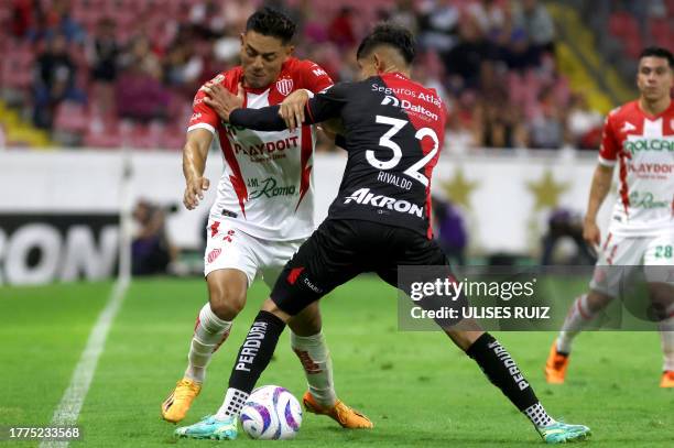 Necaxa's forward Ricardo Monreal fights for the ball with jose Atlas' defender Jose Lozano during the Mexican Apertura tournament football match...