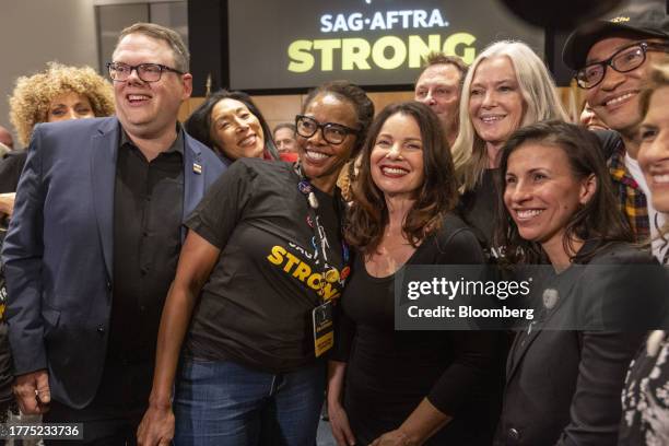 Actor Fran Drescher, president of SAG-AFTRA, center right, and Duncan Crabtree-Ireland, national executive director and chief negotiator of...