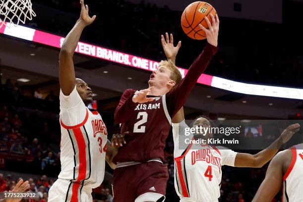 Hayden Hefner of the Texas A&M Aggies shoots the ball over the defense of Felix Okpara of the Ohio State Buckeyes and Dale Bonner during the second...
