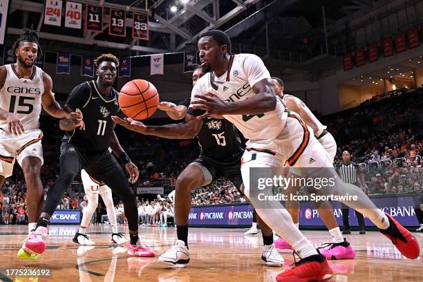 Miami guard Bensley Joseph beats UCF guard Tyler Hendricks to a rebound in the second half as the Miami Hurricanes faced the UCF Knights on November...