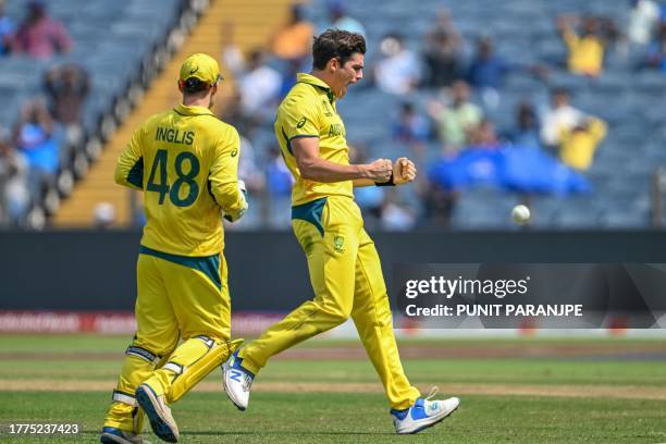 Australia's Sean Abbott celebrates with teammate Josh Inglis after taking the wicket of Bangladesh's Tanzid Hasan during the 2023 ICC Men's Cricket...