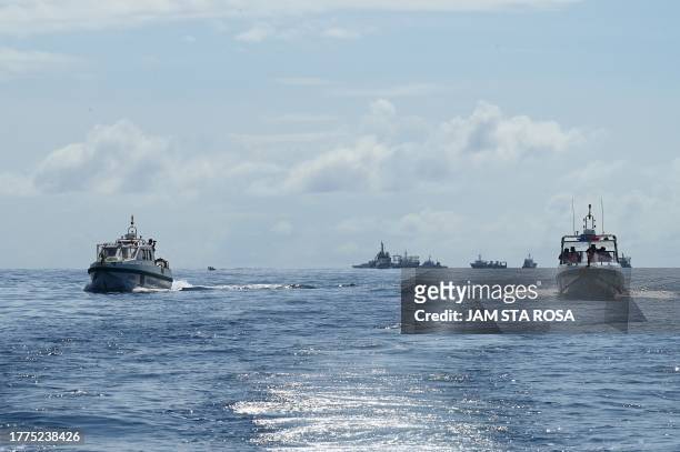 This photo taken on November 10, 2023 shows China coast guard personnel sailing aluminum hulled boats at Second Thomas Shoal in the disputed South...