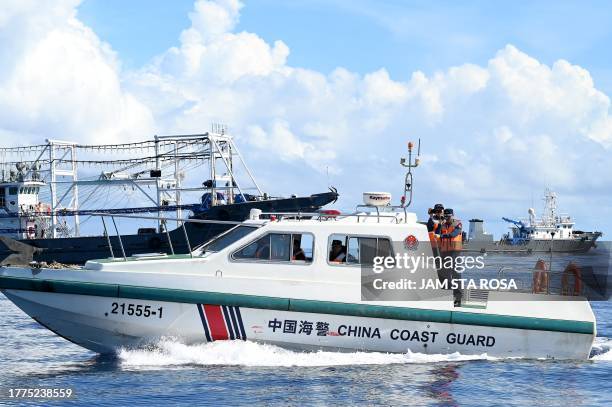 This photo taken on November 10, 2023 shows China coast guard personnel sailing aluminum hulled boats at Second Thomas Shoal in the disputed South...