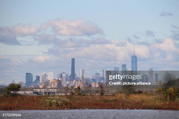 October 2023, USA, New York: The Manhattan skyline, with the Jamaica Bay Wildlife Refuge in the foreground. The Jamaica Bay Wildlife Refuge, together...