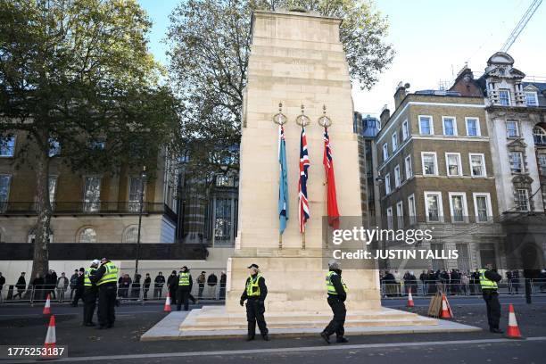 Police officers stand guard at the Cenotaph, the national War Memorial and Remembrance Site on Whitehall in central London on November 11 Armistice...