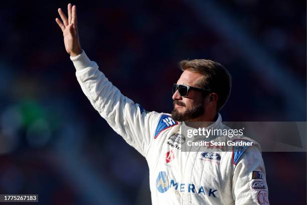 Yeley, driver of the Fan Controlled/Safelite Ford, waves to fans as he walks onstage during driver intros prior to the NASCAR Xfinity Series...