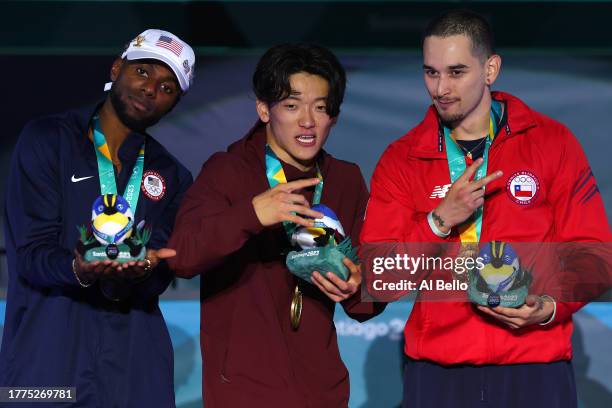 Silver medalist Jeffro of Team United States, Gold medalist Phil Wizard of Team Canada and Bronze medalist Matita of Team Chile pose on the podium...