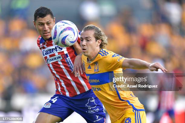 Francisco Córdova of Tigres fights for the ball with Julio Domínguez of San Luis during the 16th round match between Tigres UANL and Atletico San...