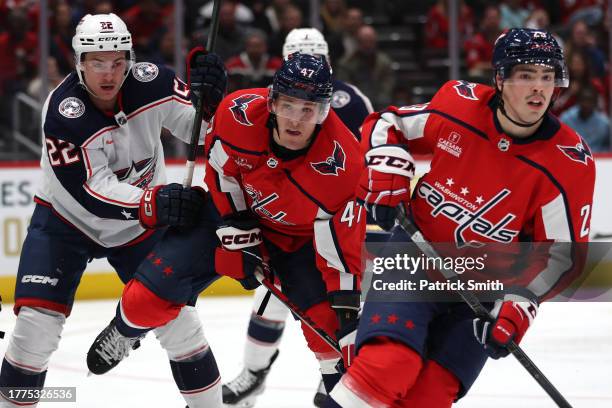 Beck Malenstyn of the Washington Capitals battles Jake Bean of the Columbus Blue Jackets for position during the second period at Capital One Arena...