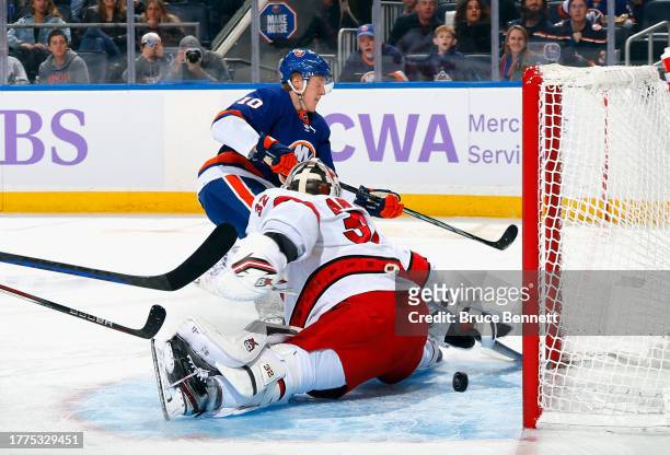 Simon Holmstrom of the New York Islanders scores a second period goal against Antti Raanta of the Carolina Hurricanes at UBS Arena on November 04,...