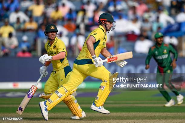 Australia's David Warner and Mitchell Marsh run between the wickets during the 2023 ICC Men's Cricket World Cup one-day international match between...
