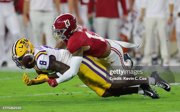 Malachi Moore of the Alabama Crimson Tide breaks up this pass intended for Malik Nabers of the LSU Tigers during the first quarter at Bryant-Denny...