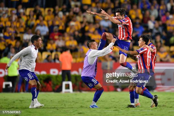 Players of San Luis celebrate after teammate Dieter Villalpando scored the team's second goal during the 16th round match between Tigres UANL and...