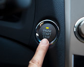 finger pressing the Engine start stop button