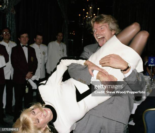 Businessman and Virgin founder Richard Branson picking up Ivana Trump and swinging her around during the Business Traveller Awards ceremony at the...