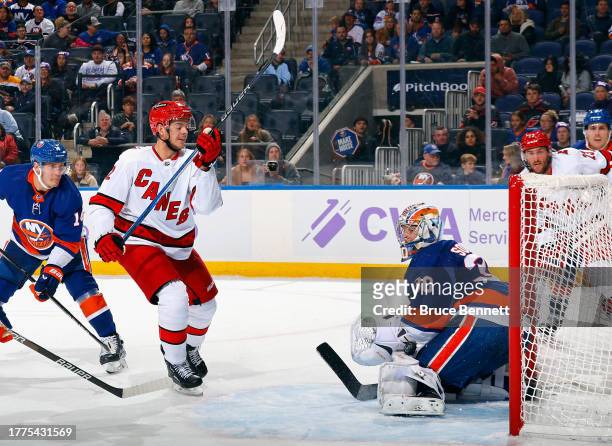 Jesperi Kotkaniemi of the Carolina Hurricanes ties the score against the New York Islanders during the third period with a shot over the pads of Ilya...