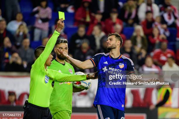 Referee Victor Rivas gives a yellow card to Matt Miazga of FC Cincinnati during the penalty kick shootout during the Audi 2023 MLS Cup Playoffs Round...