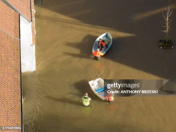 This aerial view shows rescuers with their boats as they navigate the floodwaters around the village of Neuville sous Montreuil, northern France on...