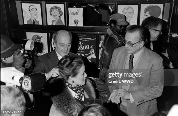 Trish Van Devere and Geroge C. Scott attend an awards ceremony at Sardi's in New York City on January 30, 1977.