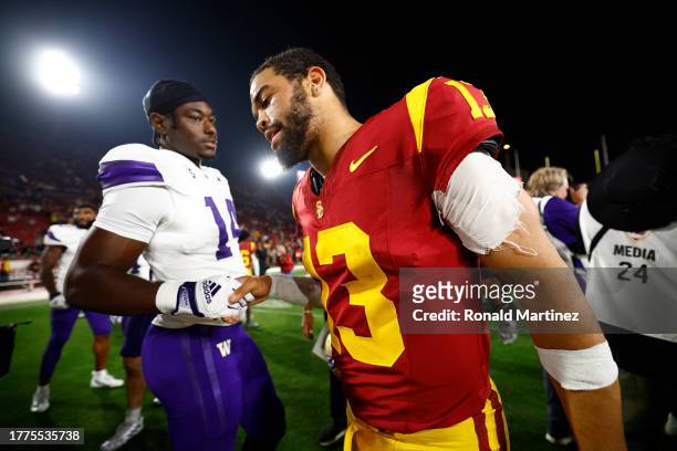 Caleb Williams of the USC Trojans shakes hands with Milton Hopkins Jr. #14 of the Washington Huskies after a game at United Airlines Field at the Los...