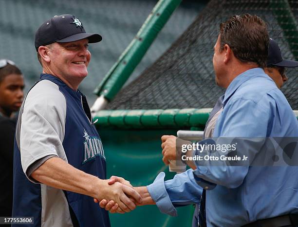 Manager Eric Wedge of the Seattle Mariners is greeted by commentator Mike Blowers during batting practice prior to the game against the Los Angeles...