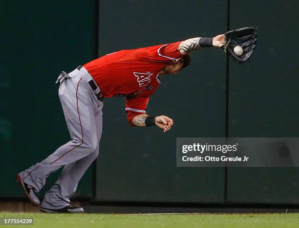 Left fielder Josh Hamilton of the Los Angeles Angels of Anaheim catches a fly off the bagt of Justin Smoak of the Seattle Mariners in the fifth...