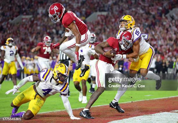 Jalen Milroe of the Alabama Crimson Tide rushes for a touchdown against Harold Perkins Jr. #4 and Sage Ryan of the LSU Tigers during the third...