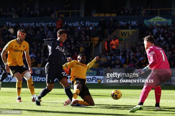 Tottenham Hotspur's Welsh striker Brennan Johnson shoots to score the opening goal of the English Premier League football match between Wolverhampton...