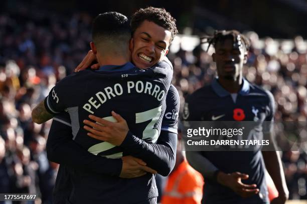 Tottenham Hotspur's Welsh striker Brennan Johnson celebrates with Tottenham Hotspur's Spanish defender Pedro Porro after scoring the opening goal of...