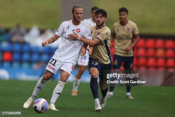 Kosta Grozos of the Jets competes for the ball with Alexia Apostolakis of the Wanderers during the A-League Men round three match between Newcastle...
