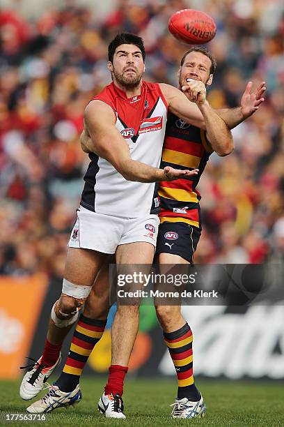 Chris Dawes of the Demons competes with Ben Rutten of the Crows during the round 22 AFL match between the Adelaide Crows and the Melbourne Demons at...