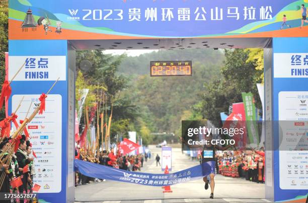 Participants sprint at the finish line of the 2023 Guizhou Ring Leigong Mountain Marathon in Leishan county, Qiandongnan, Guizhou province, China,...