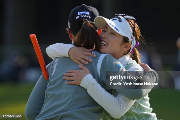 Rio Takeda and Yuna Nishimura of Japan embrace after holing out on the 18th green during the final round of the TOTO Japan Classic at the Taiheiyo...