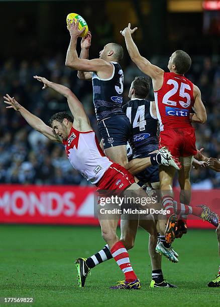 James Podsiadly of the Cats marks the ball over Shane Mumford of the Swans during the round 22 AFL match between the Geelong Cats and the Sydney...