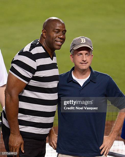 Magic Johnson and Bill Simmons attend a baseball game between the Boston Red Sox and Los Angeles Dodgers at Dodger Stadium on August 23, 2013 in Los...
