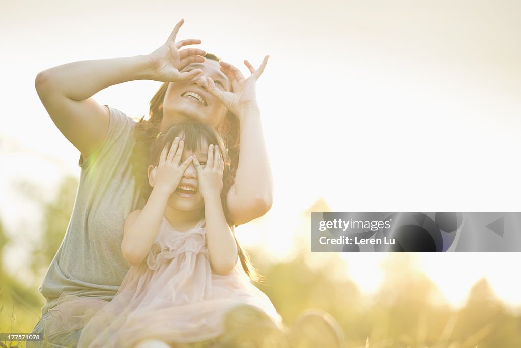 Mother and child playing under sunset